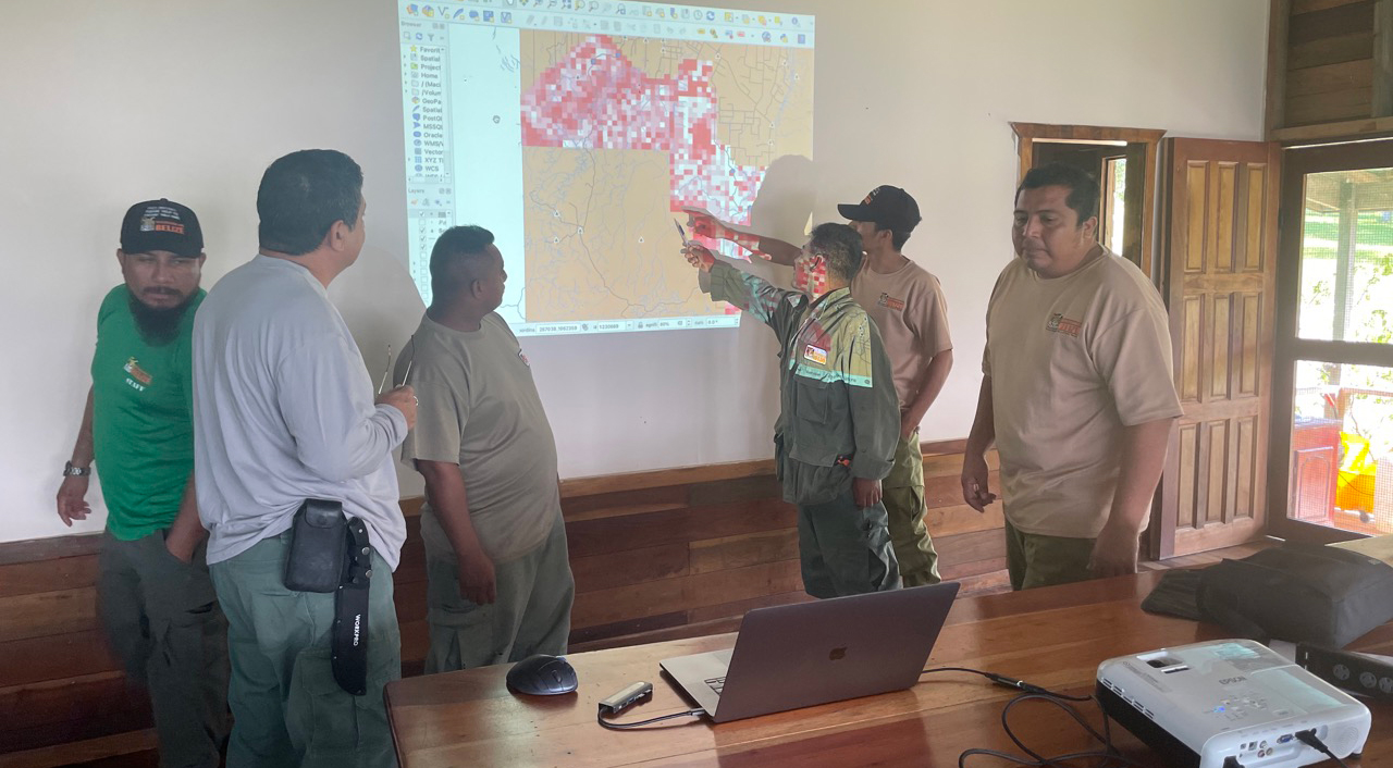 Discussing machine learning predictions of poaching hotspots with rangers in Belize.